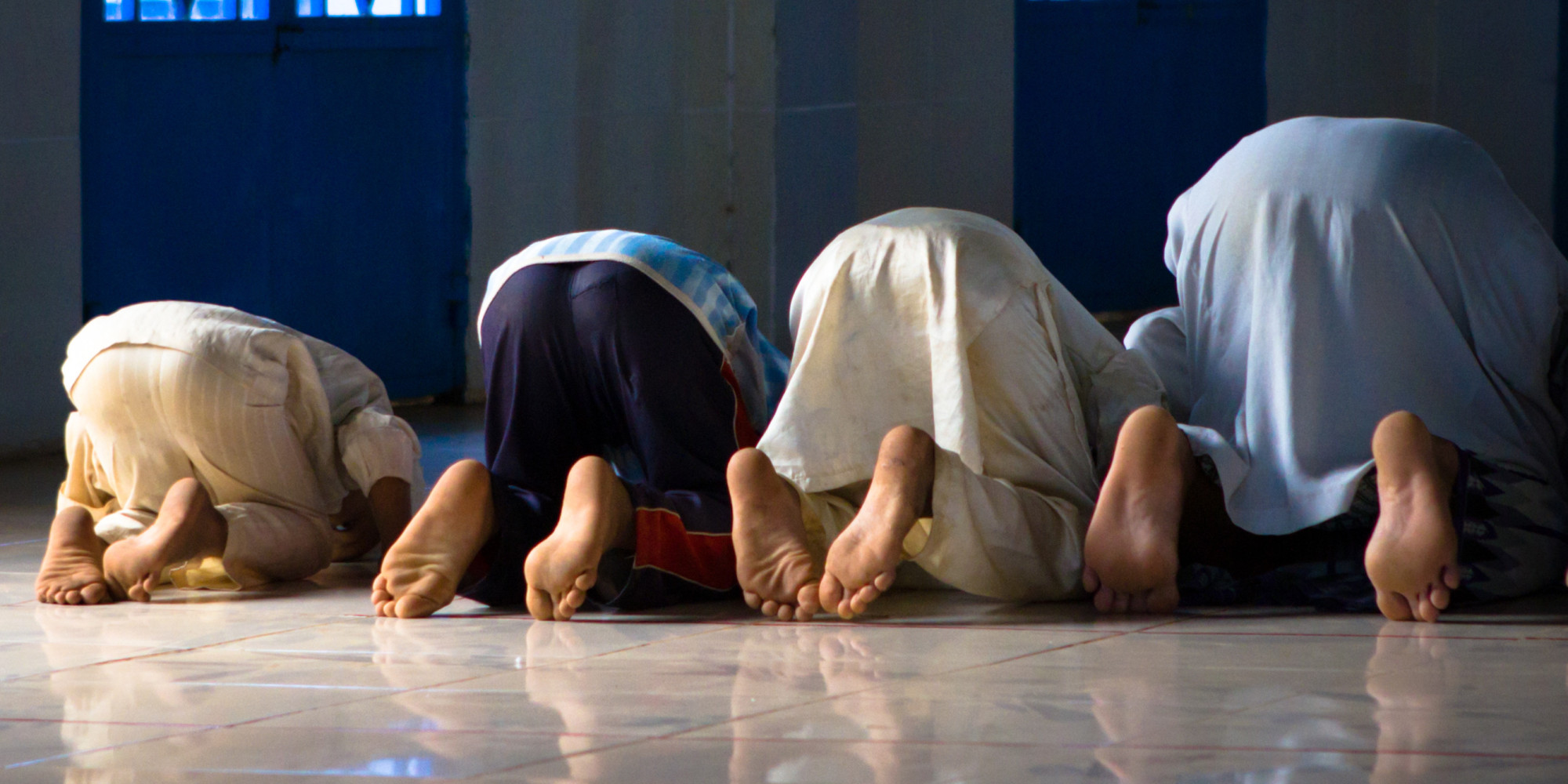  Muslim men and women are seen praying in a mosque.