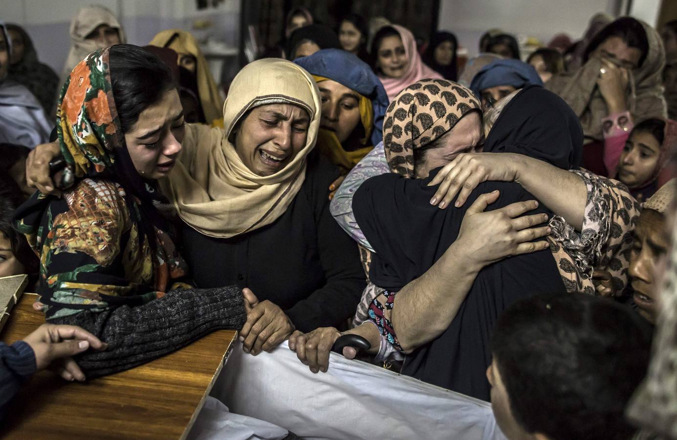 Women mourn their relative Mohammed Ali Khan, a student who was killed during an attack by Taliban gunmen on the Army Public School, at his house in Peshawar