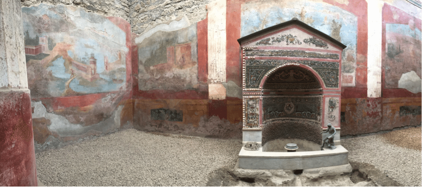 An interior of a house, so well preserved that the colour in the paintings and on the fountain remain.