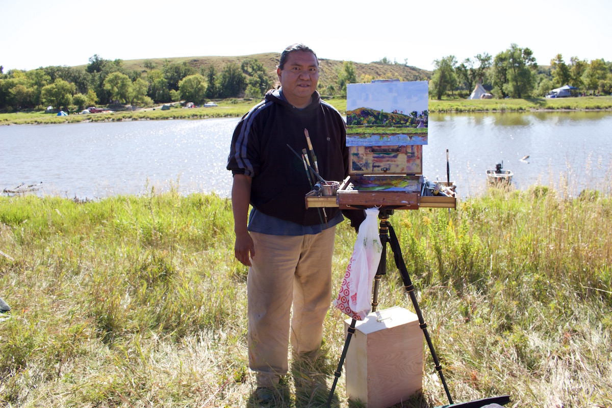 Monty Singer, artist from Albuquerque, New Mexico, paints by the Cannonball River (Photo: Nadya Tannous)